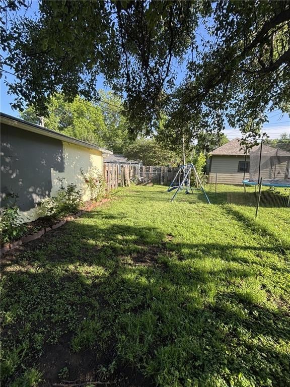 611 W Main St, Chanute, KS 66720 - view of yard featuring a trampoline