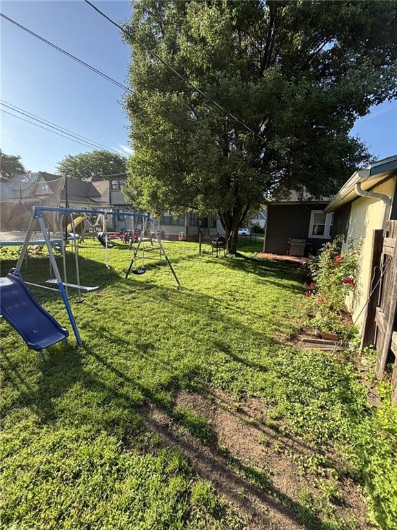 611 W Main St, Chanute, KS 66720 - view of yard with a playground and a trampoline