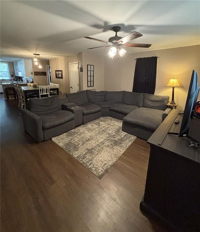 611 W Main St, Chanute, KS 66720 - living area with dark wood finished floors and ceiling fan