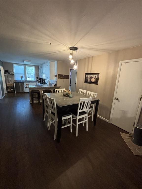611 W Main St, Chanute, KS 66720 - dining room with dark wood-style floors