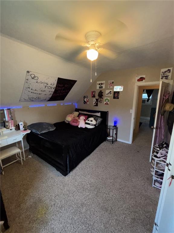 611 W Main St, Chanute, KS 66720 - bedroom with lofted ceiling, carpet, and a ceiling fan