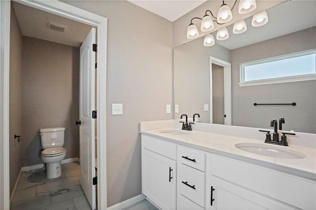 12513 S White Ash Ln, Lees Summit, MO 64086 - full bathroom with toilet, double vanity, baseboards, and marble look tiles