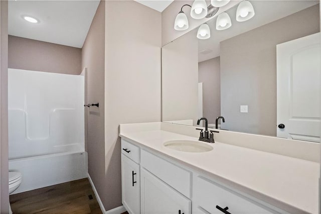 12513 S White Ash Ln, Lees Summit, MO 64086 - bathroom with wood finished floors, toilet, vanity, shower / bath combination, and baseboards