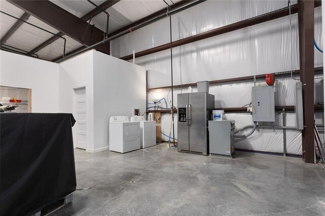 411 E 203rd St, Belton, MO 64012 - garage with stainless steel fridge with ice dispenser, electric panel, and washer and clothes dryer