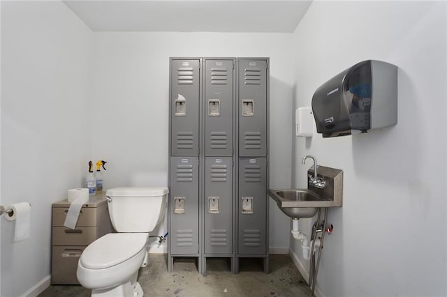 411 E 203rd St, Belton, MO 64012 - bathroom featuring toilet, baseboards, a closet, and a sink