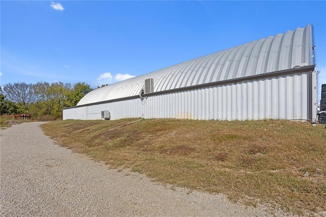 411 E 203rd St, Belton, MO 64012 - view of property exterior with an outbuilding and metal roof