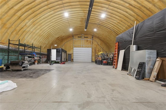 411 E 203rd St, Belton, MO 64012 - misc room with a garage, concrete flooring, and lofted ceiling