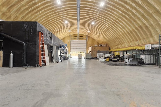411 E 203rd St, Belton, MO 64012 - miscellaneous room featuring a garage, vaulted ceiling, and concrete flooring