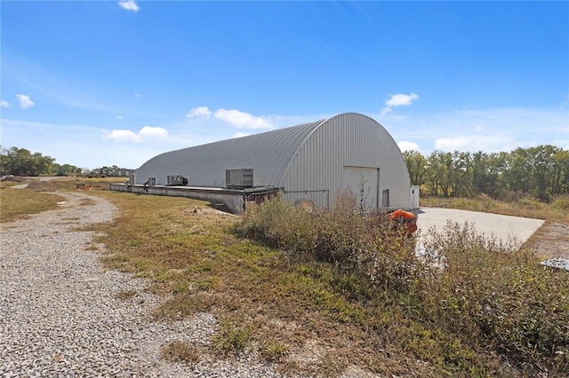 411 E 203rd St, Belton, MO 64012 - view of pole building featuring concrete driveway