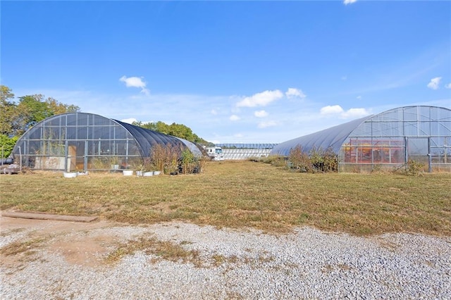 411 E 203rd St, Belton, MO 64012 - view of green lawn featuring an exterior structure and an outdoor structure