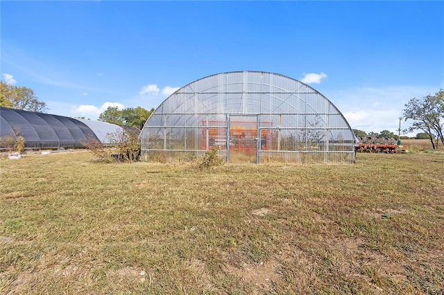 411 E 203rd St, Belton, MO 64012 - view of green lawn with a greenhouse and an outdoor structure