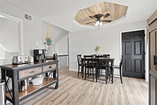 8801 NE 116th St, Kansas City, MO 64157 - dining room with ceiling fan, light wood-type flooring, and a raised ceiling