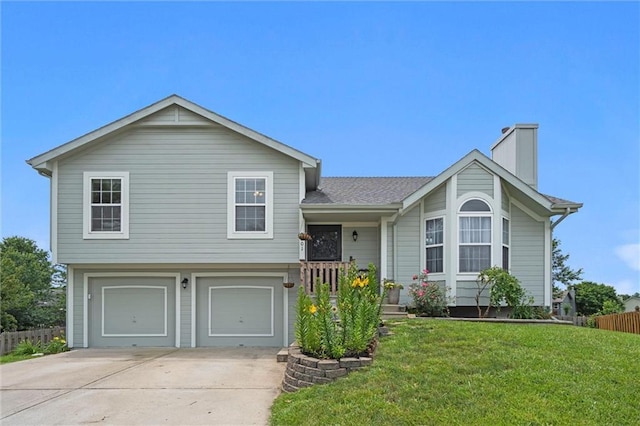 8801 NE 116th St, Kansas City, MO 64157 - tri-level home featuring driveway, an attached garage, and a chimney