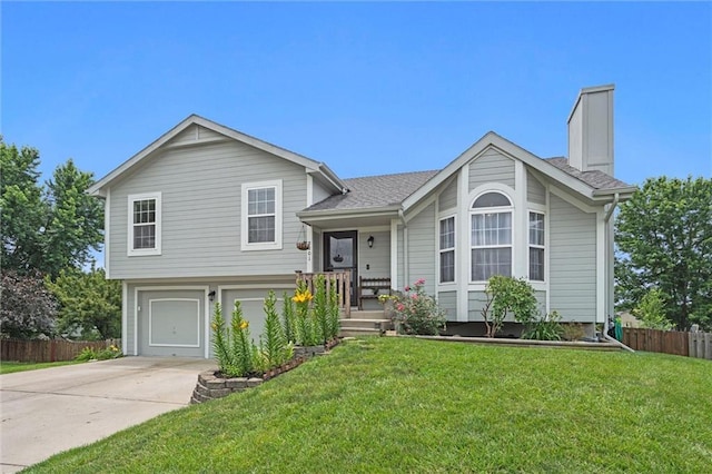 8801 NE 116th St, Kansas City, MO 64157 - split level home featuring concrete driveway, an attached garage, and a chimney