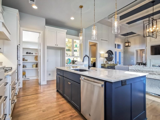 3248 W 133rd Ter, Leawood, KS 66209 - kitchen featuring stainless steel appliances, white cabinets, hanging light fixtures, light wood-style floors, and an island with sink