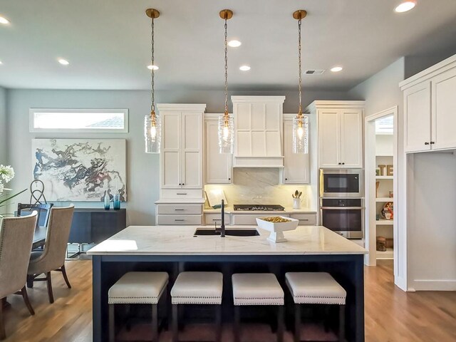 3248 W 133rd Ter, Leawood, KS 66209 - kitchen with appliances with stainless steel finishes, premium range hood, wood finished floors, decorative backsplash, and recessed lighting