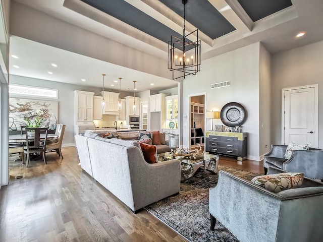 3248 W 133rd Ter, Leawood, KS 66209 - living room with a towering ceiling, a chandelier, wood finished floors, and recessed lighting