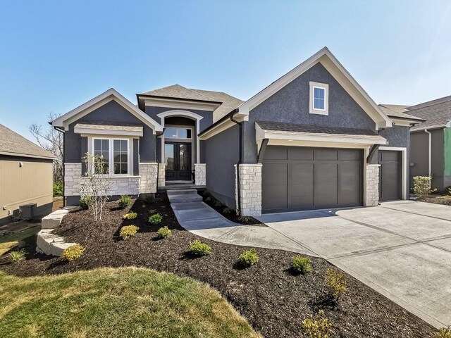 3248 W 133rd Ter, Leawood, KS 66209 - view of front facade with stucco siding, stone siding, french doors, and driveway