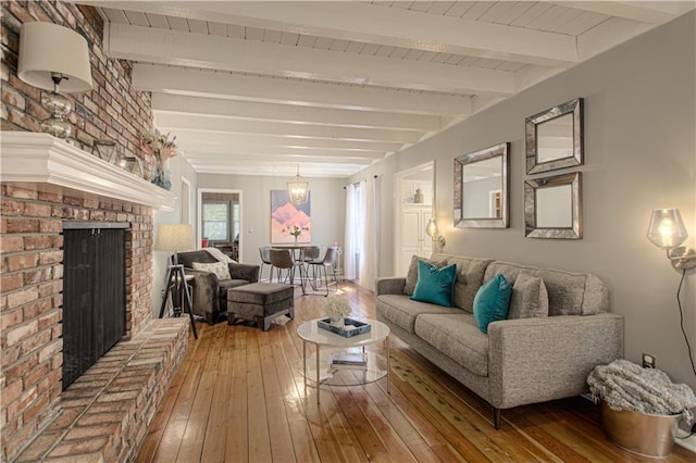 601 NW 41st St, Kansas City, MO 64116 - living area featuring wood-type flooring, beam ceiling, and a fireplace