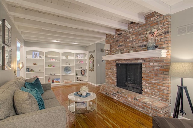 601 NW 41st St, Kansas City, MO 64116 - living area with hardwood / wood-style flooring, beam ceiling, and a fireplace