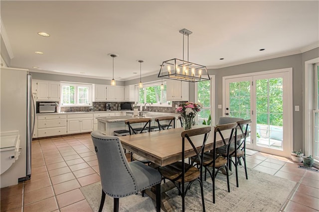 601 NW 41st St, Kansas City, MO 64116 - dining room featuring light tile patterned floors, crown molding, recessed lighting, and a chandelier
