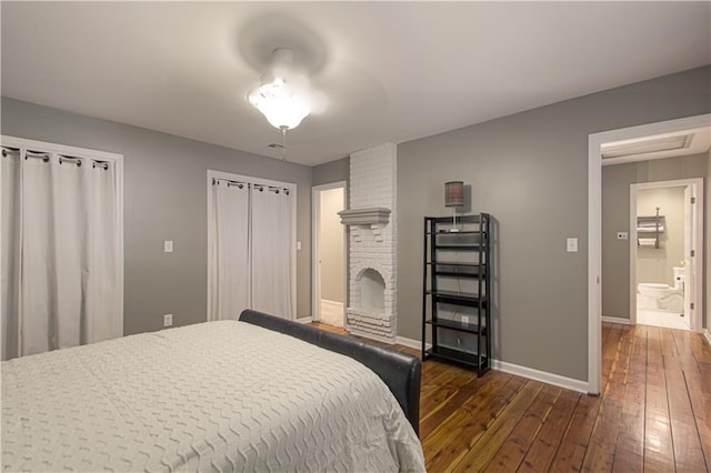 601 NW 41st St, Kansas City, MO 64116 - bedroom featuring wood-type flooring, baseboards, and a brick fireplace