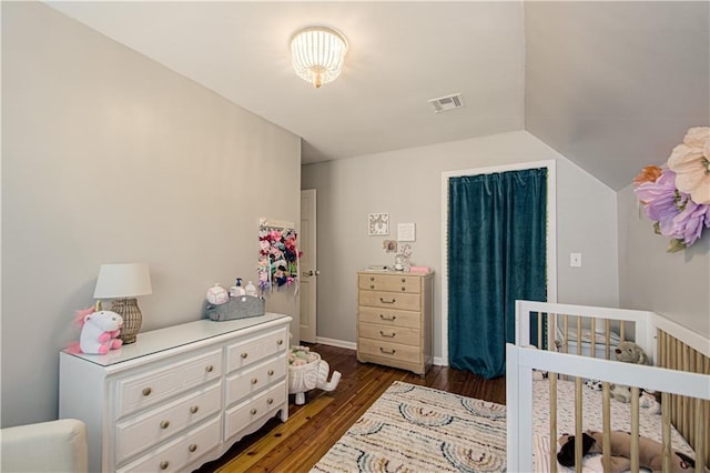 601 NW 41st St, Kansas City, MO 64116 - bedroom featuring a crib, wood finished floors, and vaulted ceiling