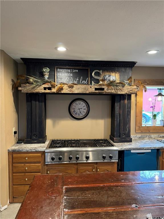 25332 E 250th Ave, Ridgeway, MO 64481 - detailed view of stainless steel gas stovetop, dishwashing machine, and dark stone countertops