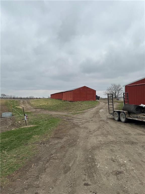 25332 E 250th Ave, Ridgeway, MO 64481 - view of dirt / gravel road with a pole building and a gated entry