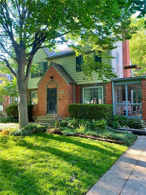 440 E 74th Ter, Kansas City, MO 64131 - view of front of property featuring brick siding, a front yard, a sunroom, and a chimney