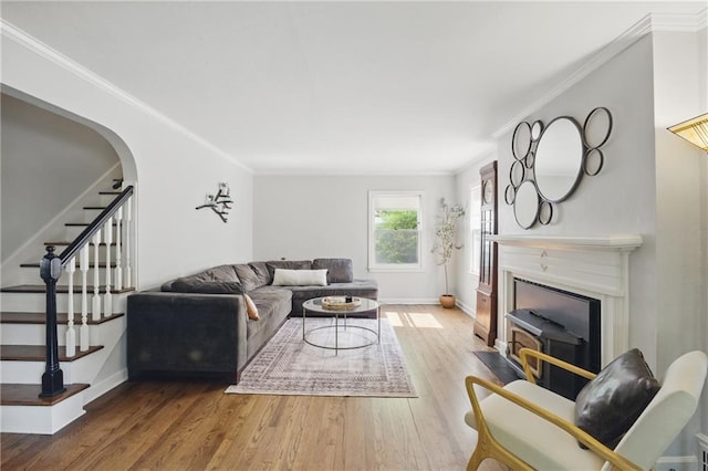440 E 74th Ter, Kansas City, MO 64131 - living room with crown molding, stairway, wood finished floors, baseboards, and a fireplace with flush hearth