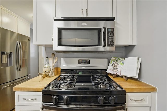 440 E 74th Ter, Kansas City, MO 64131 - kitchen with appliances with stainless steel finishes, butcher block counters, and white cabinets