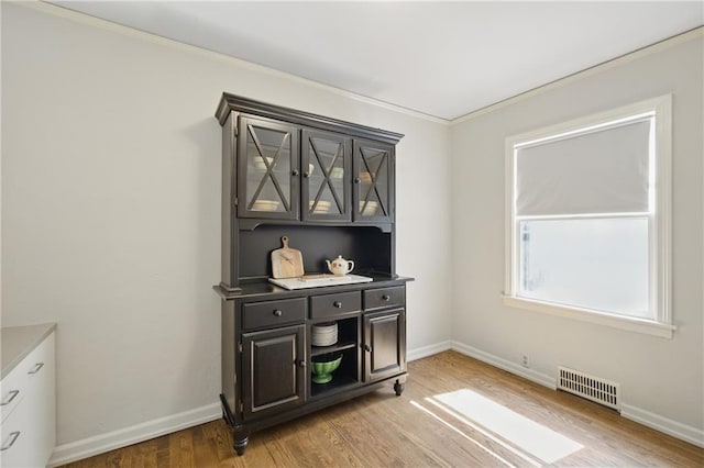 440 E 74th Ter, Kansas City, MO 64131 - dining room with light wood-style floors, ornamental molding, and baseboards