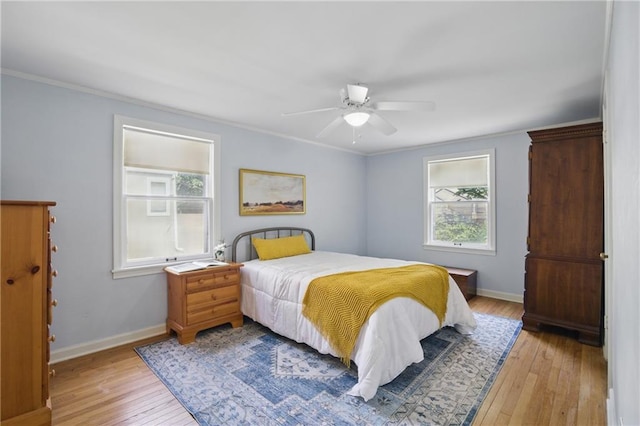 440 E 74th Ter, Kansas City, MO 64131 - bedroom featuring light wood-style floors, crown molding, baseboards, and a ceiling fan