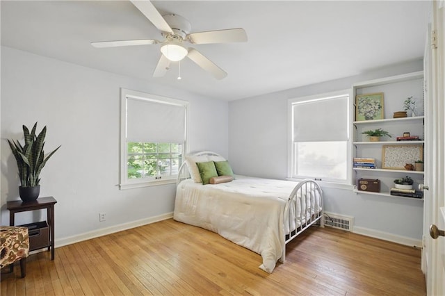 440 E 74th Ter, Kansas City, MO 64131 - bedroom featuring hardwood / wood-style floors, baseboards, and a ceiling fan