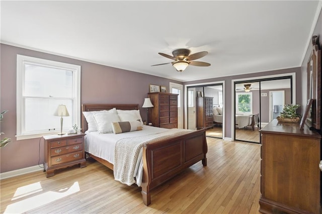 440 E 74th Ter, Kansas City, MO 64131 - bedroom featuring multiple closets, light wood finished floors, crown molding, baseboards, and a ceiling fan