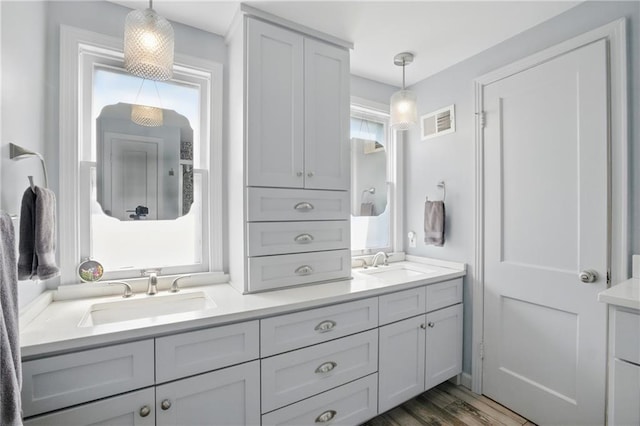 440 E 74th Ter, Kansas City, MO 64131 - bathroom with double vanity and wood finished floors