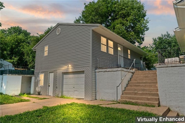 2204 S Cedar Ave, Independence, MO 64052 - view of front of property with stairs, an attached garage, and driveway