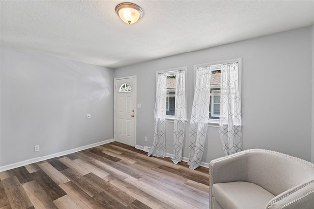 2204 S Cedar Ave, Independence, MO 64052 - entrance foyer featuring wood finished floors, baseboards, and a textured ceiling