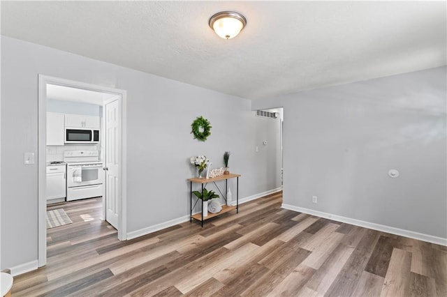 2204 S Cedar Ave, Independence, MO 64052 - unfurnished room featuring wood finished floors and baseboards