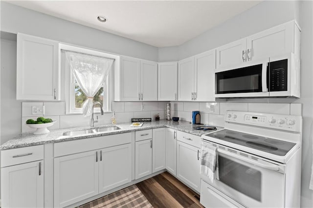 2204 S Cedar Ave, Independence, MO 64052 - kitchen featuring white appliances, a sink, white cabinetry, and dark wood-type flooring