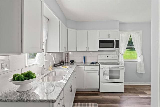 2204 S Cedar Ave, Independence, MO 64052 - kitchen featuring white appliances, a sink, backsplash, and light stone counters