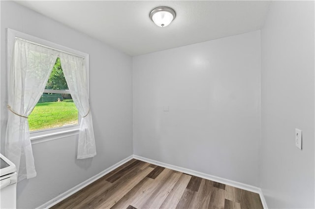 2204 S Cedar Ave, Independence, MO 64052 - spare room with wood finished floors and baseboards