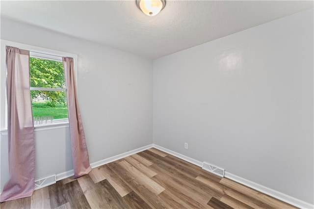 2204 S Cedar Ave, Independence, MO 64052 - empty room featuring wood finished floors and baseboards
