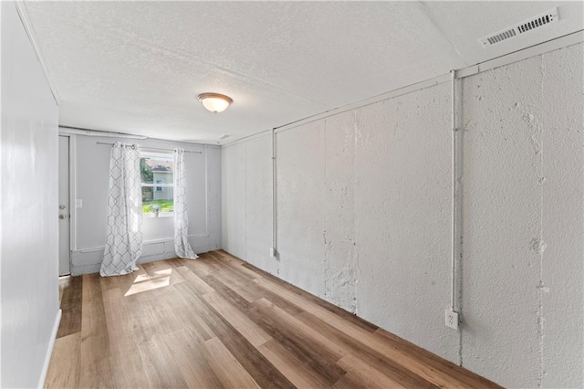 2204 S Cedar Ave, Independence, MO 64052 - empty room with wood finished floors and a textured ceiling