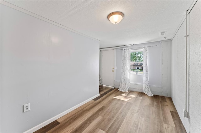 2204 S Cedar Ave, Independence, MO 64052 - unfurnished room featuring a textured ceiling, wood finished floors, and baseboards