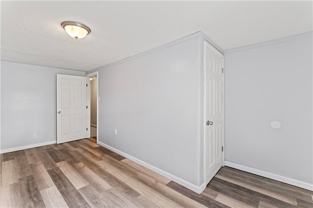 2204 S Cedar Ave, Independence, MO 64052 - empty room featuring wood finished floors, baseboards, and ornamental molding