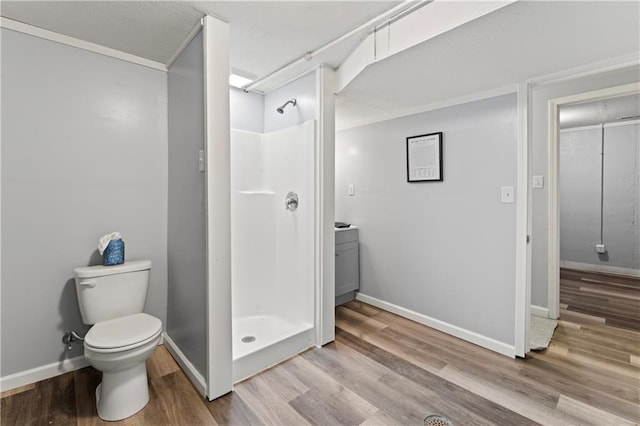 2204 S Cedar Ave, Independence, MO 64052 - bathroom featuring toilet, wood finished floors, and a stall shower