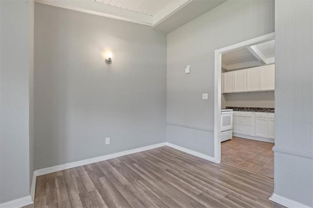 16 W 89th Ter, Kansas City, MO 64114 - spare room featuring light wood-type flooring, baseboards, and lofted ceiling