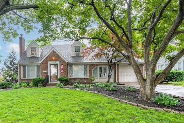 5826 Walmer St, Mission, KS 66202 - cape cod house featuring brick siding, a chimney, a front lawn, and concrete driveway